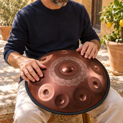 Handpan Risuono Trama ramato con decoro centrale mentre lo si suona in un cortile italiano